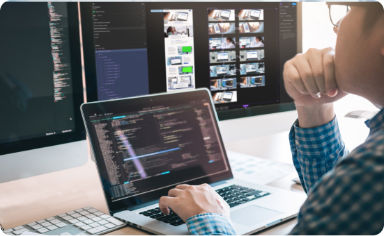 Photo of a person looking at code on a computer